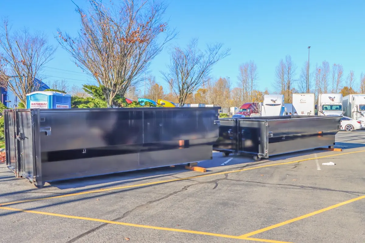 Professional dumpster rental service with roll-off container on residential driveway in Mills River